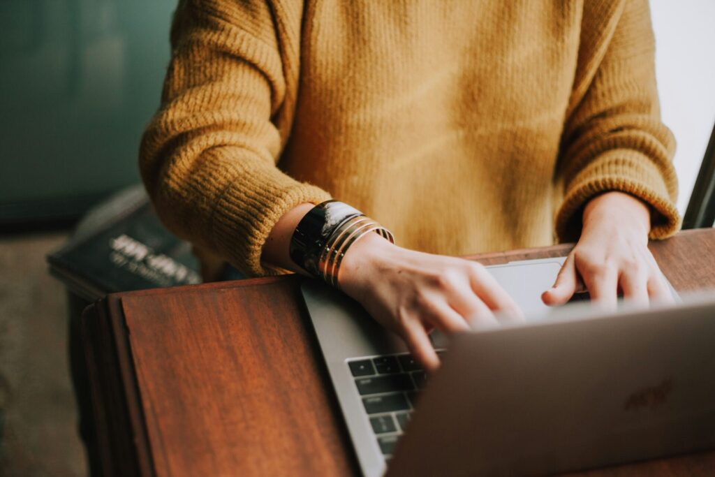 woman using her computer for online therapy