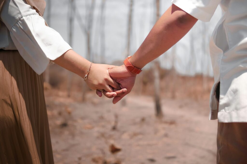 couples holding hands, walking in a forest