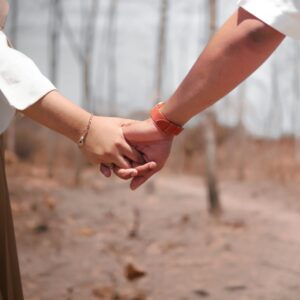 couples holding hands, walking in a forest