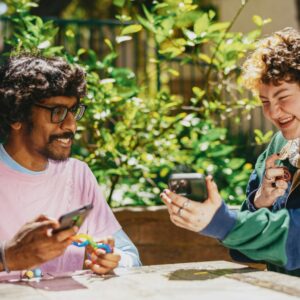 image of indian man and white girl looking at phone and smiling together